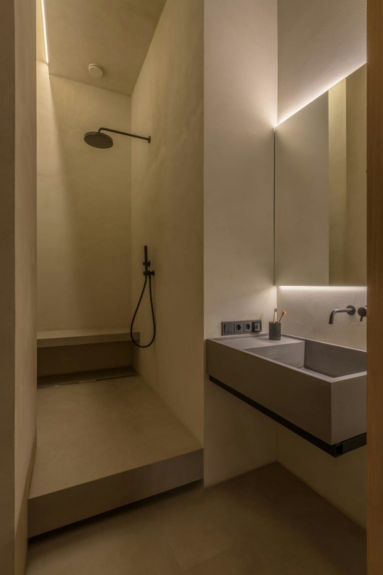 Minimalist bathroom with concrete walls and floating vanity